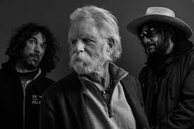 A black and white photo of three men standing next to each other.