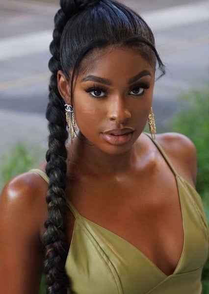 Coco Jones: A black woman wearing a green dress and a braided ponytail at Halloween Concert at RamsHead.